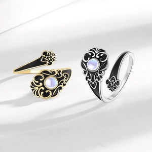 Vintage gold and silver open rings with black enamel detailing and opal center stones