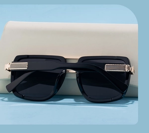Close-up of polarized sunglasses with gold striped metal hinges and beige leather case