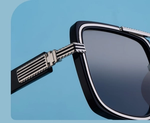 Detailed macro view of the premium silver hinge and striped black temple on sunglasses