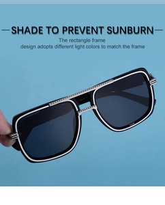 Detailed view of rectangle frame sunglasses with silver metal accents and textured top bar