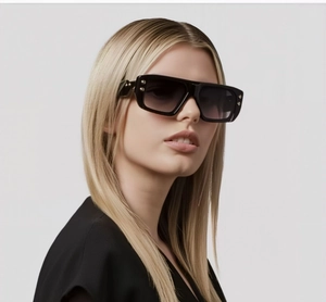 Detailed view of black square sunglasses with metallic hinges and gradient lenses