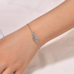 Women's angel wing bracelet in silver with light blue crystals and fine link chain