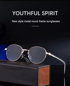 Close-up of retro oval metal sunglasses with gold frame on a premium leather case