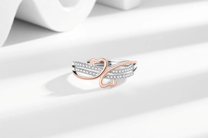 Detailed macro view of two-tone heart infinity ring with sparkling white zircon stones