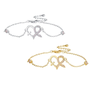 Silver and gold heart bracelets with pink crystal awareness ribbons on white background
