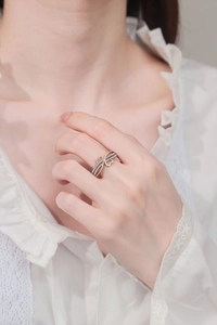 Close-up of two-tone heart ring with cubic zirconia on a female model finger