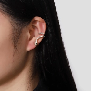 Elegant snake ear cuff in gold finish with sparkling pavé stones and green gem eyes