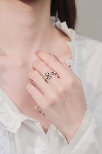 Detail of vintage silver adjustable ring with lucky cloud motif on a model's hand