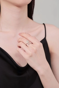 Detailed view of silver open ring with butterfly and floral diamond-set accents