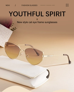 Close-up of cat-eye sunglasses with gold metal frame and gradient brown lenses