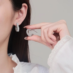 Elegant hollow heart stud earrings with baguette-cut pavé zircons in silver finish