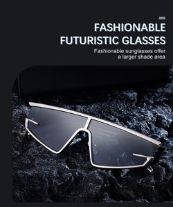 Futuristic silver metal sunglasses with dark gray lenses displayed on dark volcanic rock