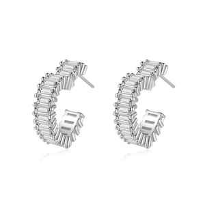 Silver hollow heart earrings with baguette-cut zircon crystals on white mirror background