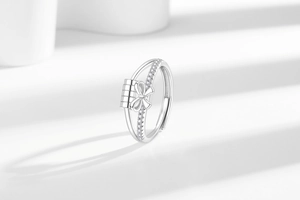 Macro shot of silver-tone spinner ring with sparkling bow and detailed zircon inlay