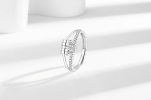 Detailed close-up of a silver fidget ring featuring a heart-shaped rotating element with cubic zirconia