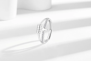 Close-up of double layer spinning ring with cross charm and crystal encrusted band