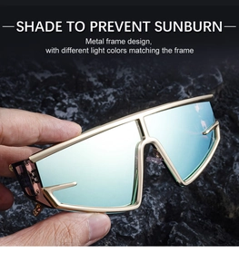 Detail of futuristic gold metal frame sunglasses with light blue mirrored lenses