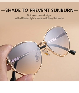Detailed view of cat eye sunglasses with gold metal frame and gradient lenses
