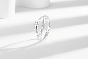 Macro detail of rotating fidget beads and sparkling zircon stones on silver ring