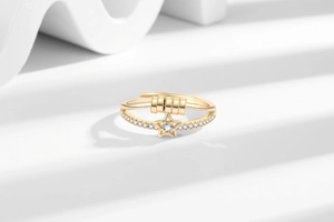 Detail of rotatable gold-plated spinning ring with star charm and pavé zircon stones