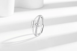 Macro detail of rotating beads and star motif on polished anti-anxiety spinner ring