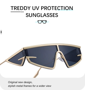Detail of futuristic gold metal sunglasses with UV protection and grey lenses
