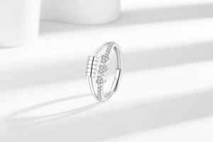 Macro shot of spinning anti-stress beads on silver heart ring with sparkling crystals