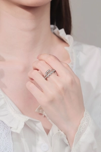 Detail of a rotating heart-shaped anti-stress ring set with sparkling small crystals