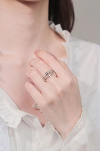 Close-up of double-layer spinning ring with silver beads and cross detail