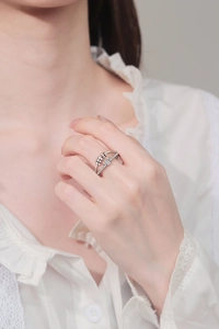 Detail of a rotating crown spinner ring with beads on a model hand for anxiety relief