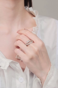 Close-up of a rotating bead anxiety ring with micro-pave crystals on model finger