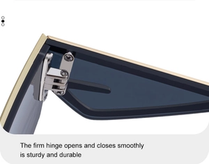 Detail of sturdy metal hinge on cat-eye sunglasses with blue-grey lenses and gold frame