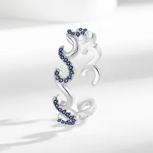 Minimalist silver wave open ring featuring sparkling blue zircon stones and S-shape design