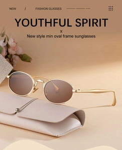 Close-up of gold oval sunglasses with brown lenses next to a beige leather case