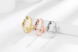 Detailed view of adjustable anxiety rings in gold, rose gold and silver with movable beads