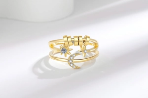 Detailed macro view of gold-plated celestial ring featuring spinning anti-anxiety beads