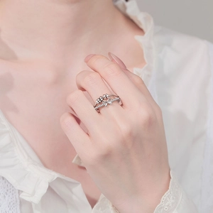 Anxiety relief bow ring with rotating beads and sparkling cubic zirconia in silver