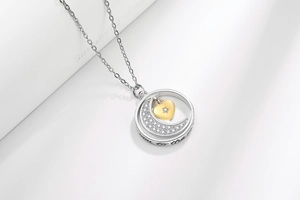 Macro detail of moon and star necklace with Love You to the Moon and Back engraving