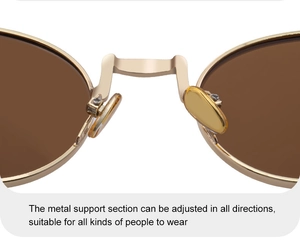 Detailed close-up of adjustable nose pads on gold metal oval sunglasses with brown lenses