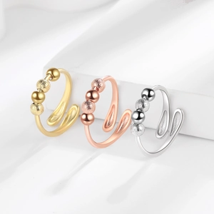 Adjustable anxiety spinner rings with three movable beads in gold, rose gold and silver finish