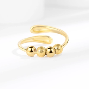Adjustable golden spinner ring with four alternating polished and frosted beads