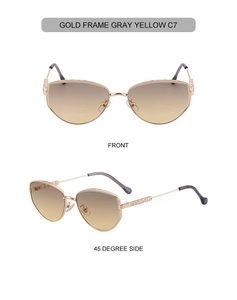 Detail view of gold metal sunglasses with gray yellow gradient lenses and geometric carved hinges