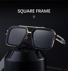 Close-up of square sunglasses with black frame, gold double bridge and metal details