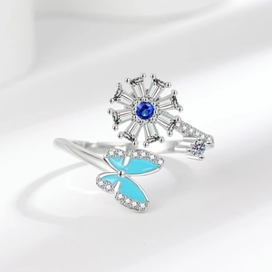 Rotating snowflake and butterfly spinner ring with blue crystals and silver plating