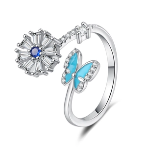 Adjustable spinner ring featuring a rotating blue floral stone and crystal butterfly