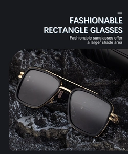 Détail de lunettes de soleil carrées polarisées avec monture dorée sur un rocher noir