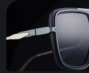 Detail of premium golden metal hinge on square matte black and blue sunglasses