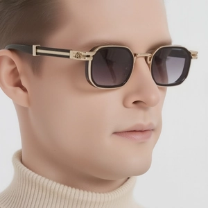 Detail of premium black square sunglasses showing golden metal logo and gradient lenses