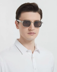 Close-up of retro square sunglasses with silver metal frame and cross pattern detailing