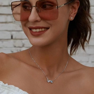 Silver butterfly jewelry set with blue zircon crystals on necklace and earrings